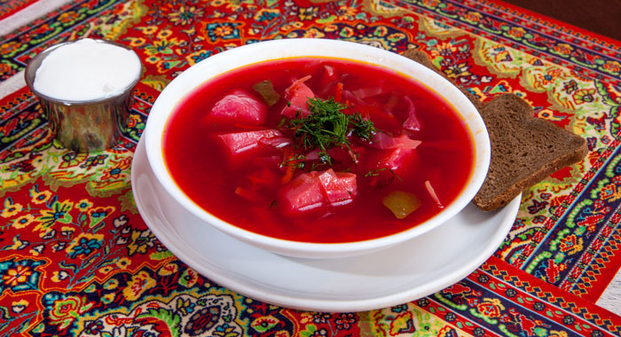 A bowl of richly colored, tasty looking borscht